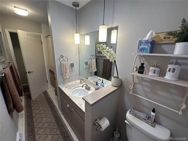 bathroom with vanity, toilet, curtained shower, and tile patterned floors