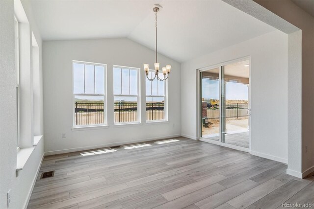 25254 E Warren Pl, Aurora, CO 80018 - unfurnished dining area featuring healthy amount of natural light, a chandelier, light wood-style floors, and lofted ceiling