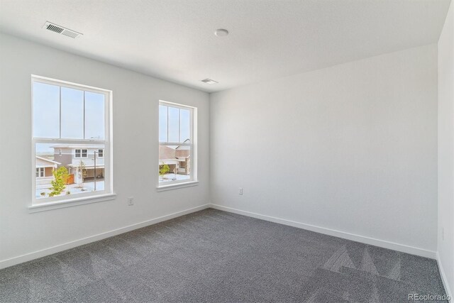 25254 E Warren Pl, Aurora, CO 80018 - unfurnished room featuring dark colored carpet and baseboards