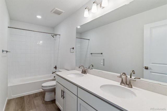 25254 E Warren Pl, Aurora, CO 80018 - bathroom with wood finished floors, toilet, double vanity, bathtub / shower combination, and recessed lighting