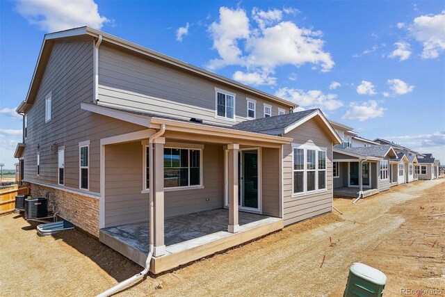 25254 E Warren Pl, Aurora, CO 80018 - back of house with central AC and a patio area
