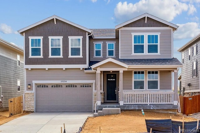 25254 E Warren Pl, Aurora, CO 80018 - craftsman inspired home with a porch, concrete driveway, an attached garage, and stone siding