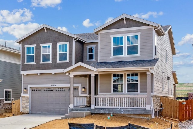 25254 E Warren Pl, Aurora, CO 80018 - craftsman-style home featuring covered porch, driveway, a garage, stone siding, and a shingled roof