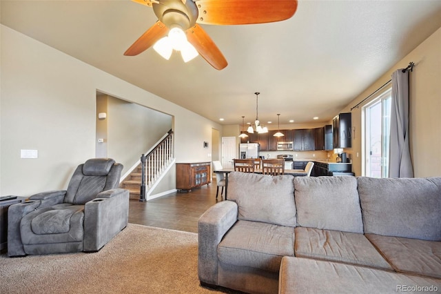 12766 Sunlight Peak Pl, Peyton, CO 80831 - living area with stairs, ceiling fan, baseboards, and dark carpet