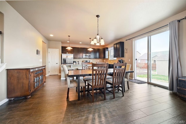 12766 Sunlight Peak Pl, Peyton, CO 80831 - dining space with a chandelier, recessed lighting, dark wood-type flooring, and baseboards