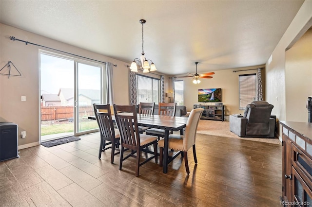 12766 Sunlight Peak Pl, Peyton, CO 80831 - dining room featuring a chandelier, ceiling fan, baseboards, and wood finished floors