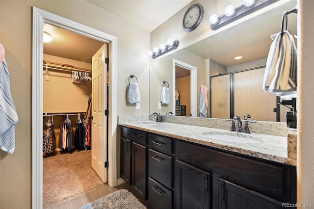 12766 Sunlight Peak Pl, Peyton, CO 80831 - full bath with a stall shower, a spacious closet, and double vanity