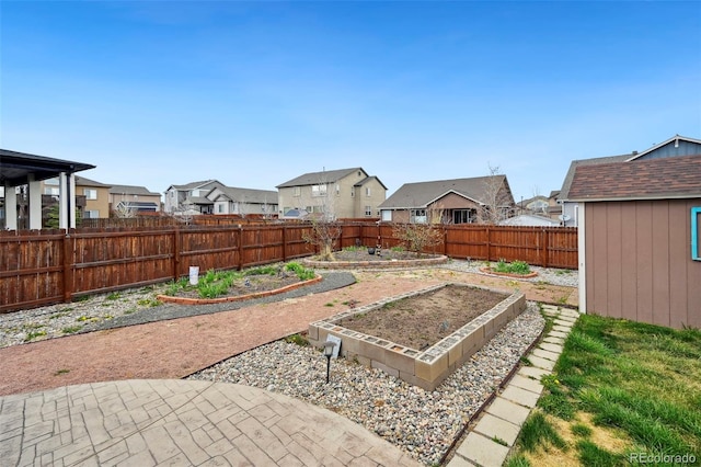 12766 Sunlight Peak Pl, Peyton, CO 80831 - fenced backyard with a vegetable garden, a residential view, and an outbuilding