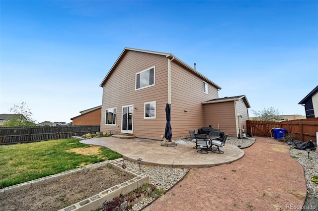 12766 Sunlight Peak Pl, Peyton, CO 80831 - rear view of property featuring a patio, entry steps, and a vegetable garden