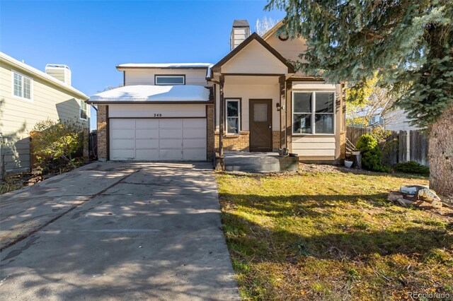 view of front of home with a garage and a front lawn