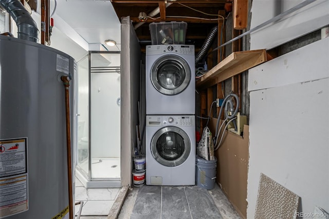 washroom with stacked washer / drying machine and water heater