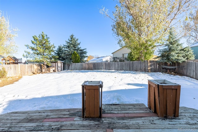 yard covered in snow with a storage shed