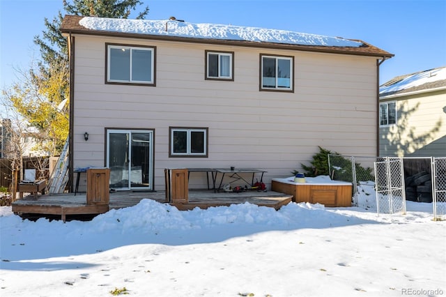 snow covered property with a wooden deck