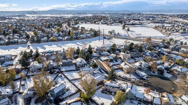 snowy aerial view featuring a mountain view