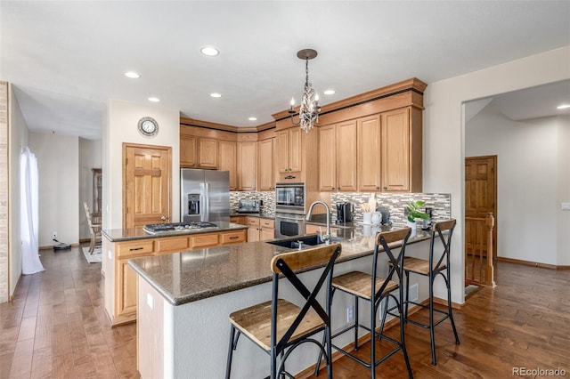 5048 Rocky Mountain Dr, Castle Rock, CO 80109 - kitchen featuring stainless steel appliances, a sink, a peninsula, tasteful backsplash, and recessed lighting