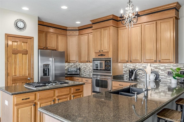 5048 Rocky Mountain Dr, Castle Rock, CO 80109 - kitchen featuring appliances with stainless steel finishes, a sink, backsplash, a peninsula, and dark stone countertops