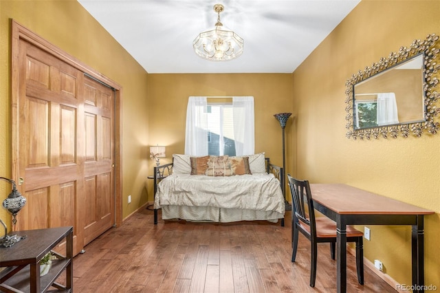 5048 Rocky Mountain Dr, Castle Rock, CO 80109 - bedroom with a chandelier, wood-type flooring, and baseboards