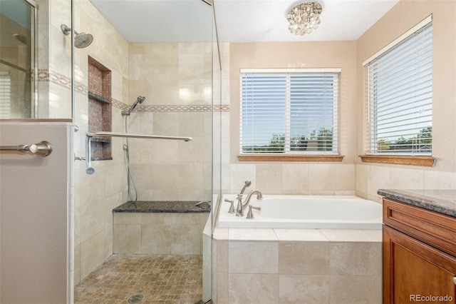 5048 Rocky Mountain Dr, Castle Rock, CO 80109 - bathroom featuring a bath, a shower stall, vanity, and a chandelier