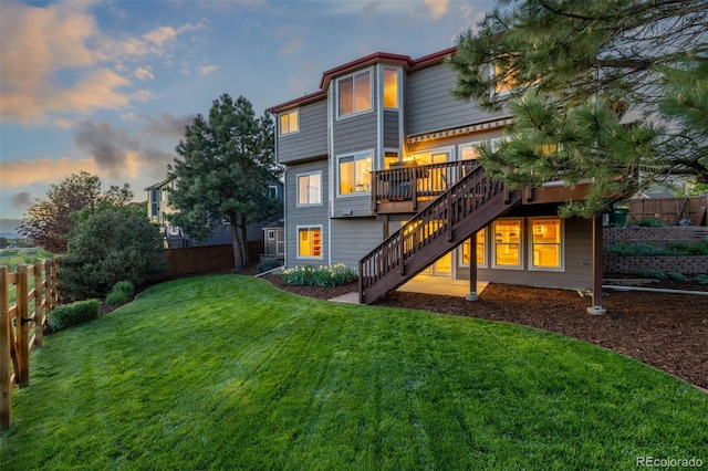 5048 Rocky Mountain Dr, Castle Rock, CO 80109 - back of property at dusk featuring stairway and a deck