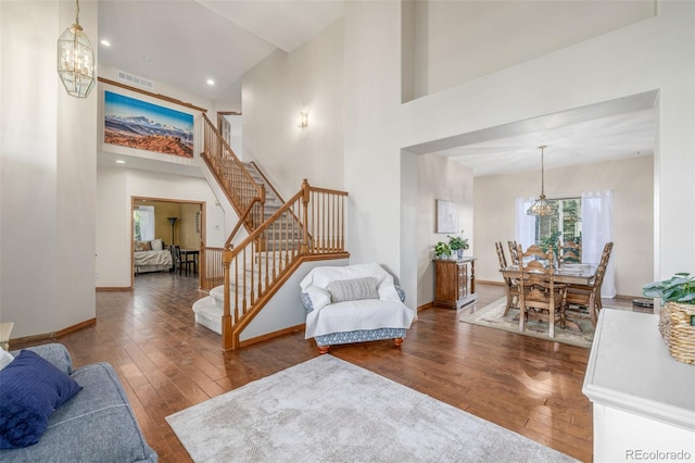 5048 Rocky Mountain Dr, Castle Rock, CO 80109 - living area featuring a chandelier, hardwood / wood-style flooring, stairs, baseboards, and a high ceiling