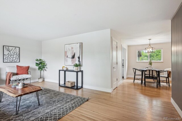8490 E Davies Pl, Centennial, CO 80112 - living room featuring light wood-style floors and a chandelier
