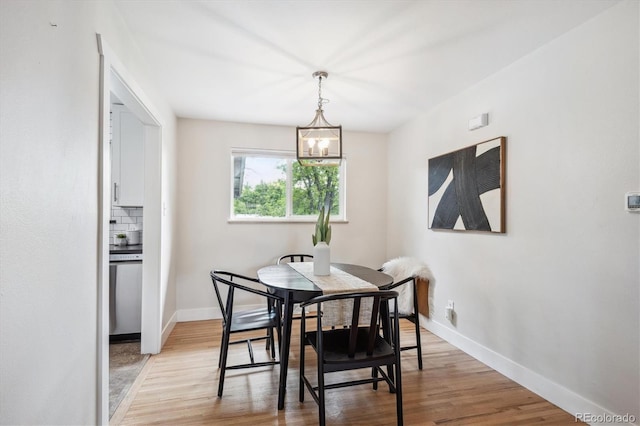 8490 E Davies Pl, Centennial, CO 80112 - dining space with light wood-style floors and a chandelier