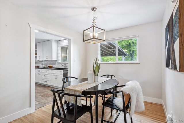 8490 E Davies Pl, Centennial, CO 80112 - dining area featuring a chandelier and light wood finished floors