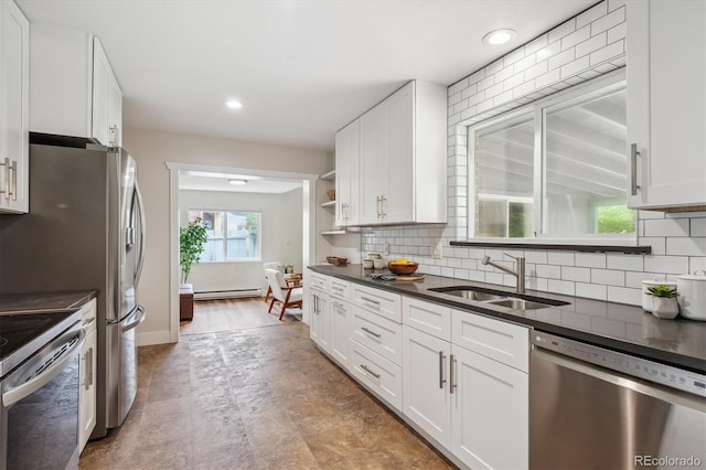 8490 E Davies Pl, Centennial, CO 80112 - kitchen with stainless steel appliances, dark countertops, baseboard heating, white cabinetry, and recessed lighting