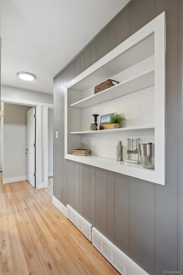 8490 E Davies Pl, Centennial, CO 80112 - corridor featuring wood finished floors, built in features, and wood walls