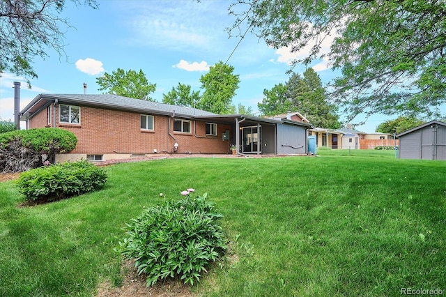 8490 E Davies Pl, Centennial, CO 80112 - back of property with a yard, brick siding, and an outdoor structure