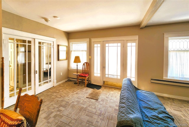 interior space featuring a baseboard heating unit, carpet, baseboards, beam ceiling, and french doors