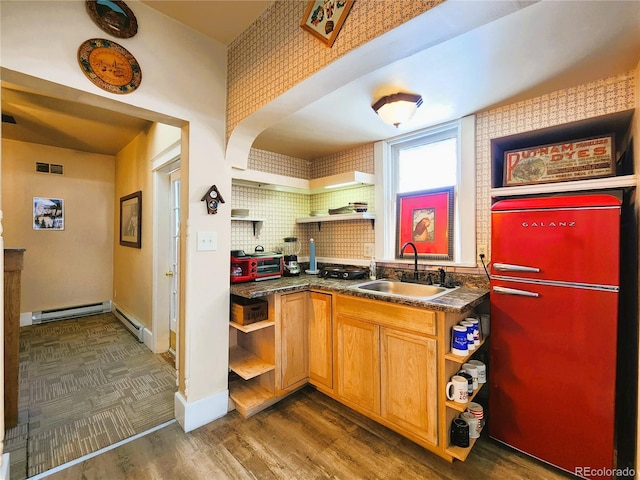 kitchen with visible vents, open shelves, a sink, dark countertops, and wood finished floors