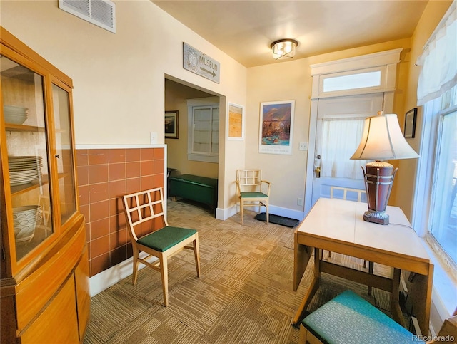 interior space with visible vents and light colored carpet