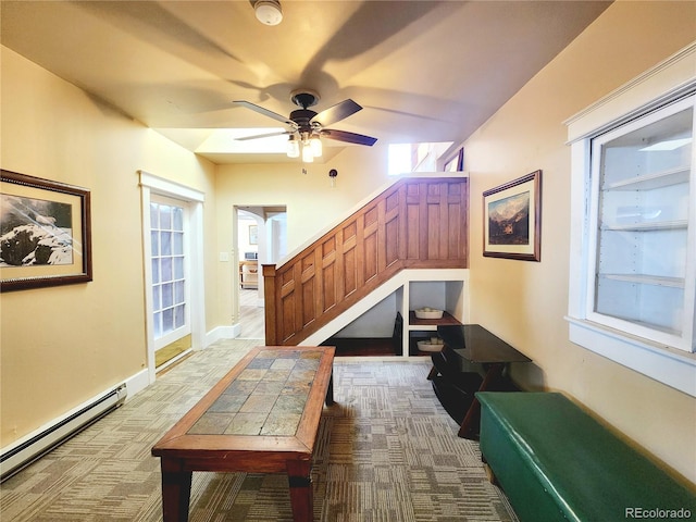 interior space with stairway, baseboard heating, and carpet