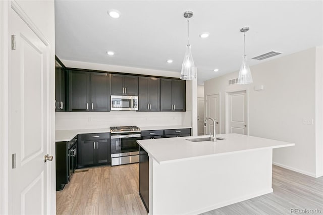 13342 E 110th Way, Commerce City, CO 80022 - kitchen with stainless steel appliances, a sink, decorative backsplash, light countertops, and light wood-type flooring