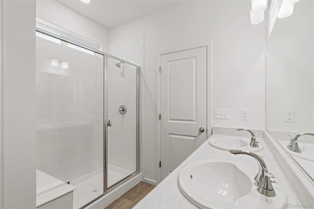 13342 E 110th Way, Commerce City, CO 80022 - bathroom featuring a shower stall, wood finished floors, and double vanity