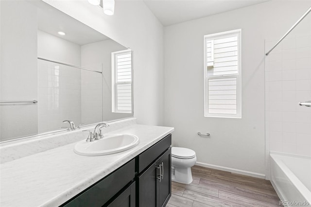 13342 E 110th Way, Commerce City, CO 80022 - full bathroom with vanity, toilet, plenty of natural light, and wood finished floors