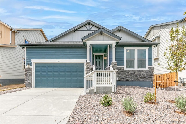 13342 E 110th Way, Commerce City, CO 80022 - craftsman-style home featuring an attached garage, stone siding, concrete driveway, and board and batten siding