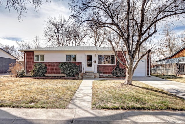 ranch-style home with driveway, brick siding, a front yard, and fence