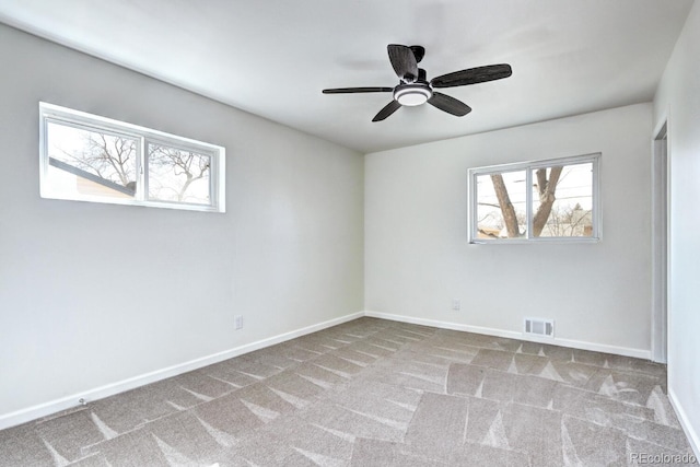 spare room featuring visible vents, ceiling fan, baseboards, and carpet floors