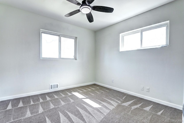 unfurnished room featuring baseboards, visible vents, carpet floors, and a healthy amount of sunlight