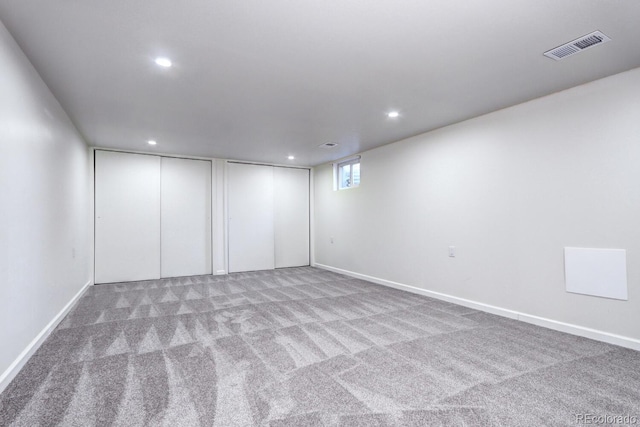 interior space with carpet flooring, recessed lighting, visible vents, and baseboards