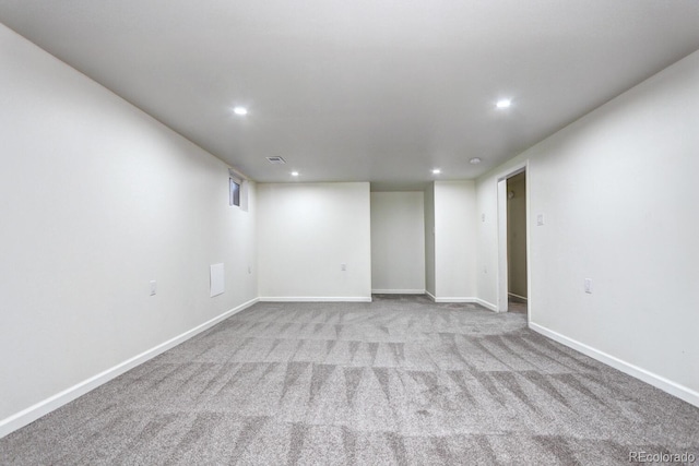 empty room with carpet flooring, recessed lighting, and baseboards