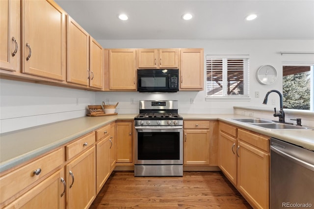 kitchen featuring plenty of natural light, sink, light brown cabinets, and appliances with stainless steel finishes