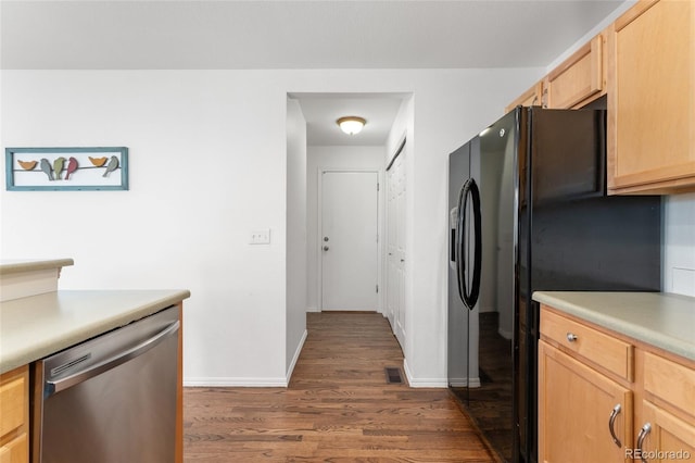 kitchen featuring light brown cabinetry, black refrigerator, dishwasher, and dark hardwood / wood-style flooring