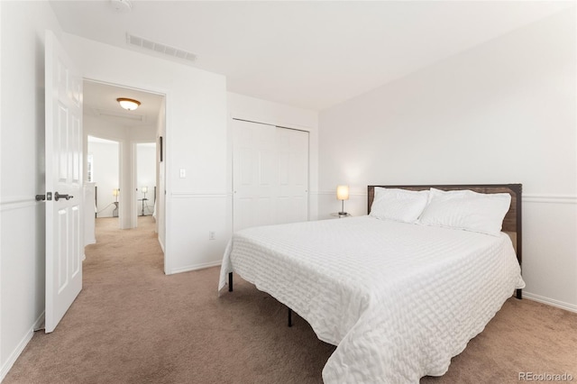 bedroom featuring light colored carpet and a closet