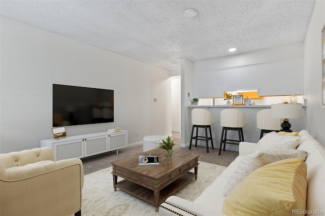 2707 Valmont Rd Unit 106, Boulder, CO 80304 - carpeted living area featuring a textured ceiling and baseboards