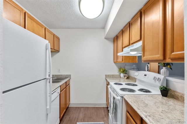 2707 Valmont Rd Unit 106, Boulder, CO 80304 - kitchen with white appliances, under cabinet range hood, light wood-type flooring, light countertops, and a textured ceiling