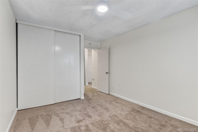 2707 Valmont Rd Unit 106, Boulder, CO 80304 - unfurnished bedroom with a textured ceiling, carpet flooring, a closet, and ceiling fan