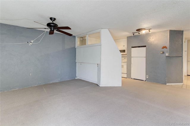 unfurnished living room featuring light carpet, a textured ceiling, and ceiling fan